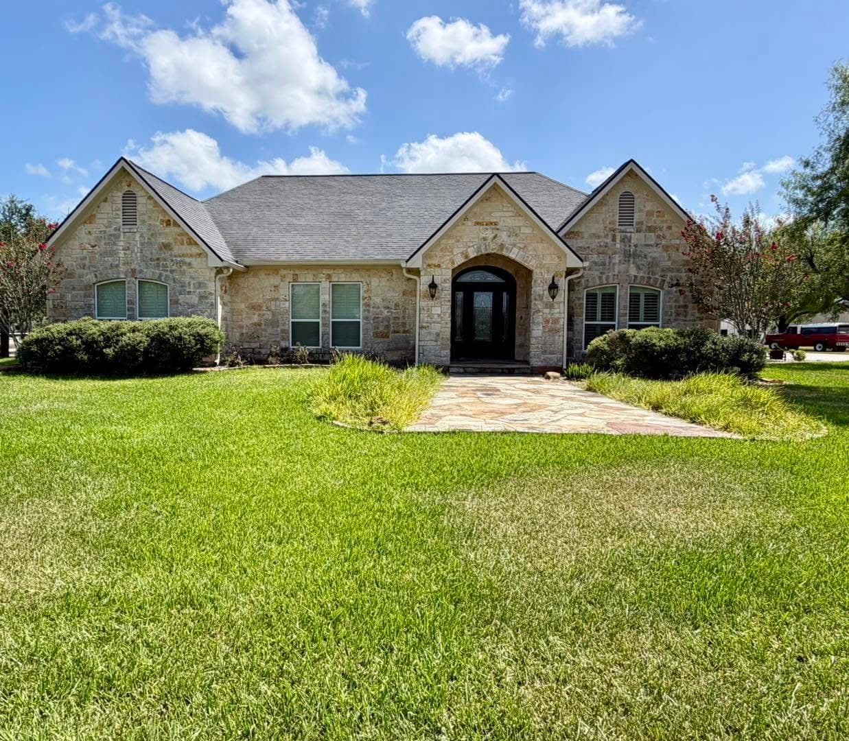 Stone-front Coastal Bend home with a finished seamless gutter system