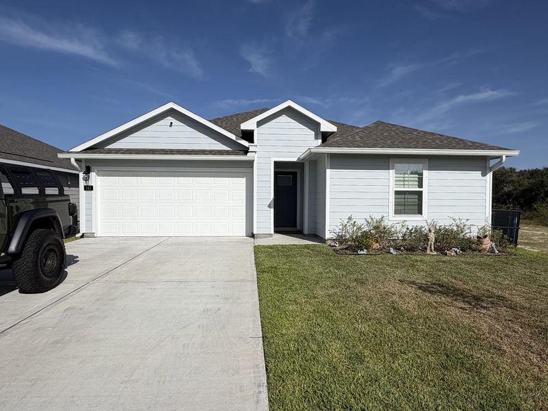Light gray siding home with new seamless gutters near Rockport and Aransas Pass, by J Seamless Gutters