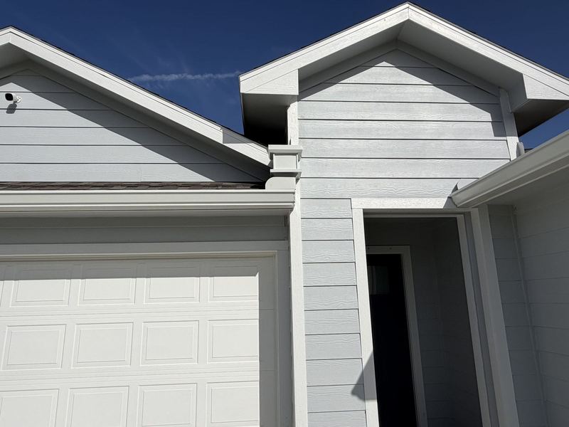 White seamless gutter corner and roofline junction in Rockport by J Seamless Gutters