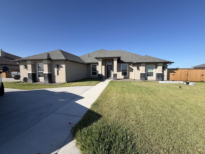 New beige stucco ranch with seamless gutters in the Corpus Christi area