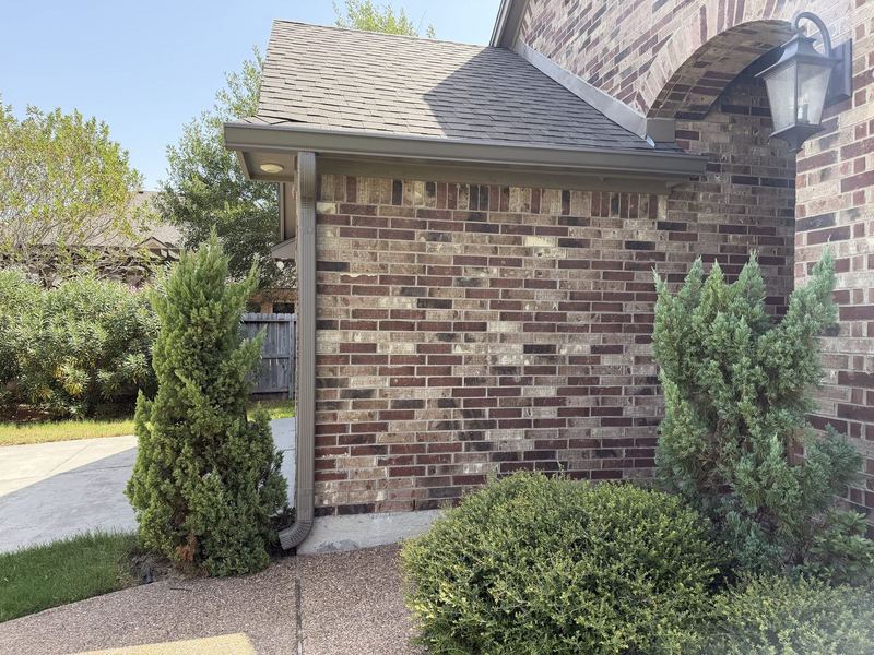 Close-up of a downspout on brick in Portland, TX