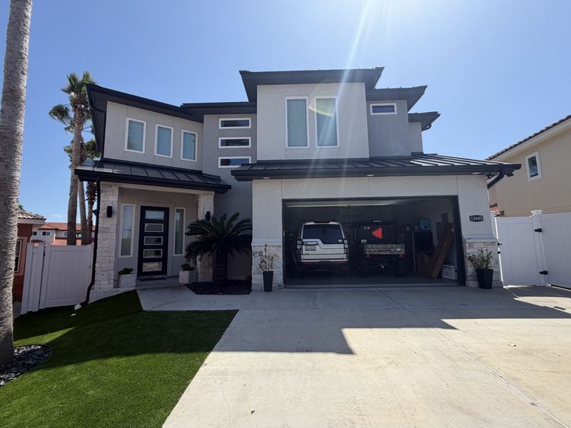 Modern white two-story, black gutters — Corpus Christi, TX