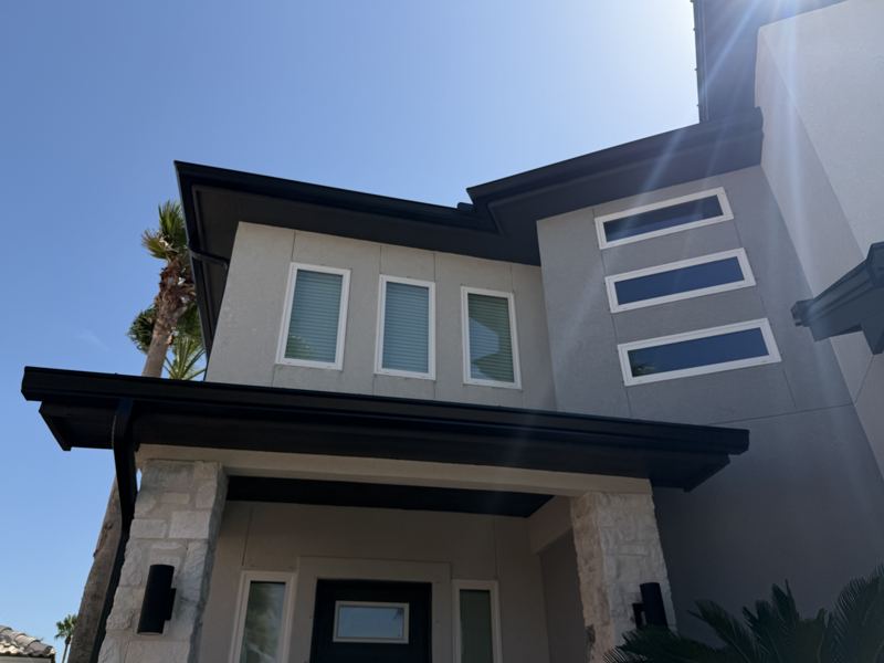 Modern white two-story, black gutters — Corpus Christi, TX