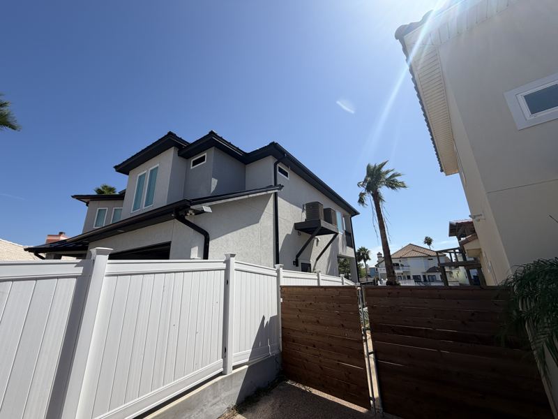Modern white two-story, black gutters — Corpus Christi, TX