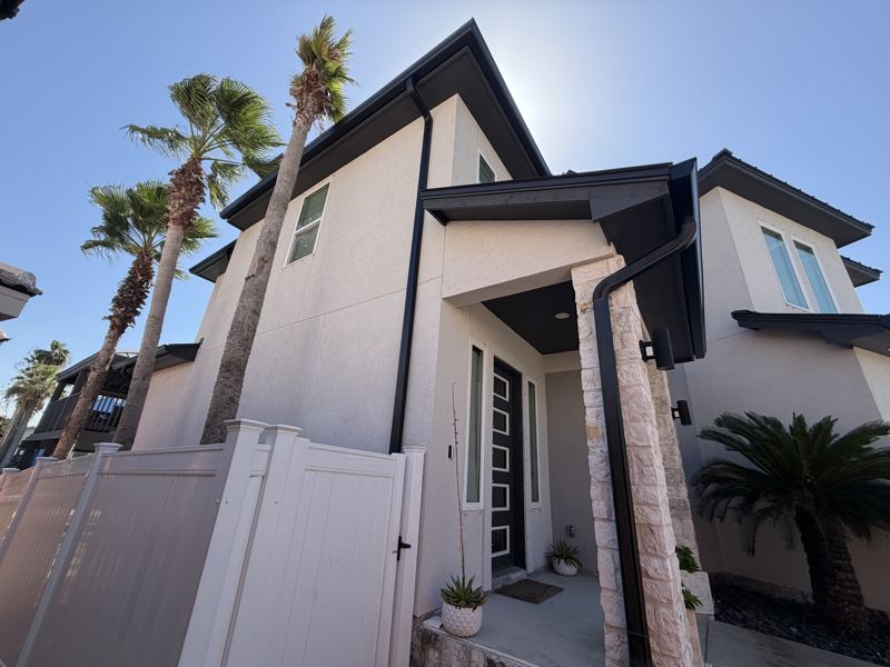 Modern white two-story, black gutters — Corpus Christi, TX