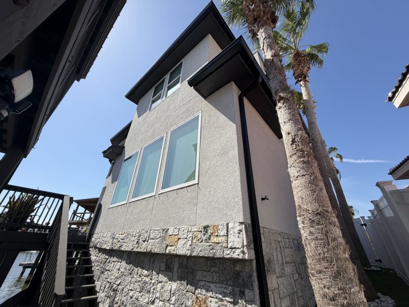 Modern white two-story, black gutters — Corpus Christi, TX