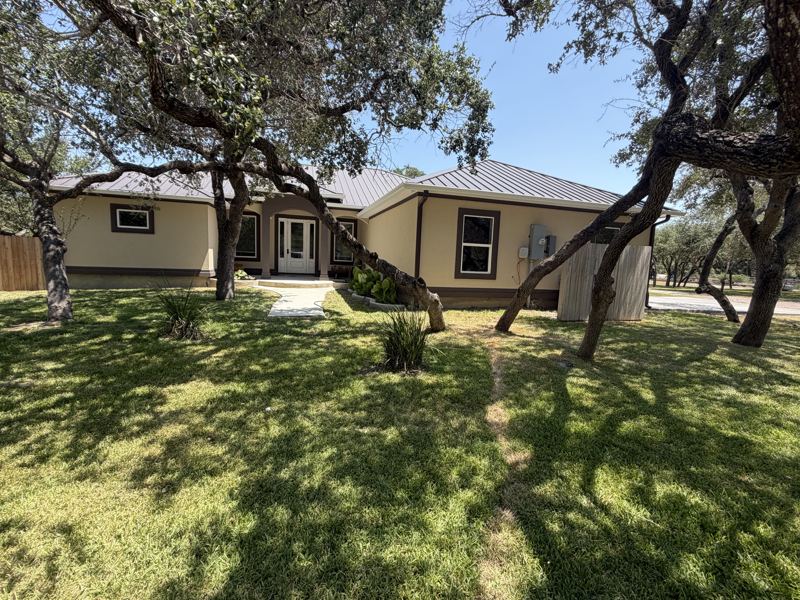 Tan home under the oaks, with pool — Fulton, TX