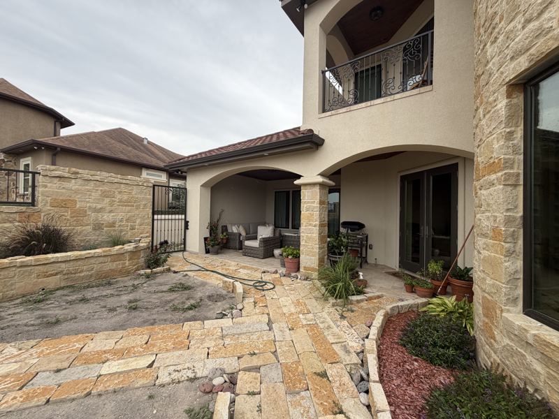 Tan stucco and stone home — Corpus Christi, TX