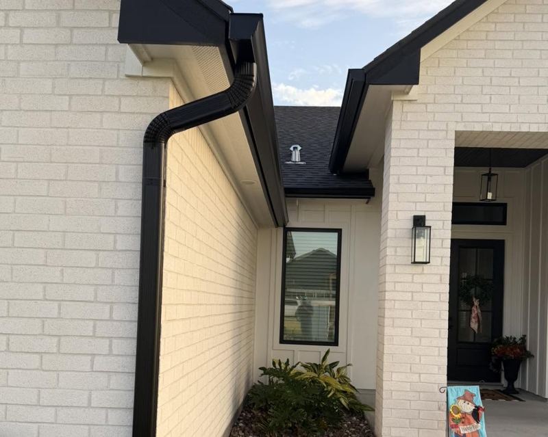 White brick and board-and-batten home, black gutters — Corpus Christi Area, Oct 2026