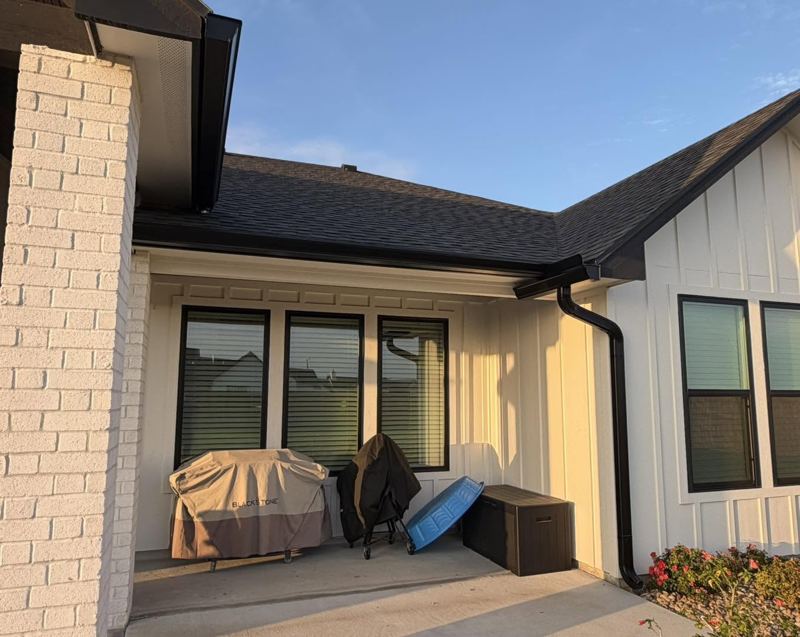 White brick and board-and-batten home, black gutters — Corpus Christi Area, Oct 2026