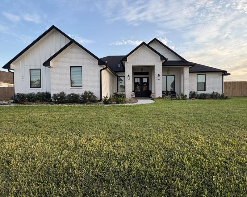White brick and board-and-batten home, black gutters — Corpus Christi Area, Oct 2026